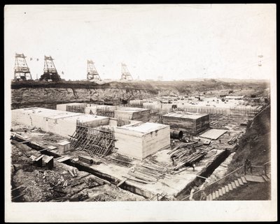 View of construction of the Panama Canal with concrete forms and excavation visible by Byron Company